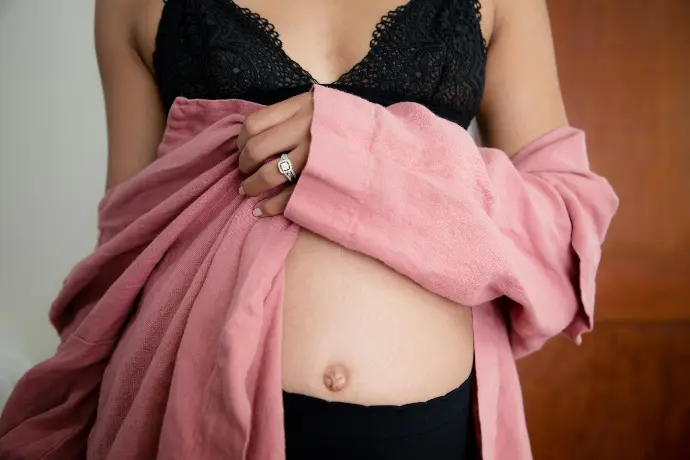 girl wearing pink jacket and black bra